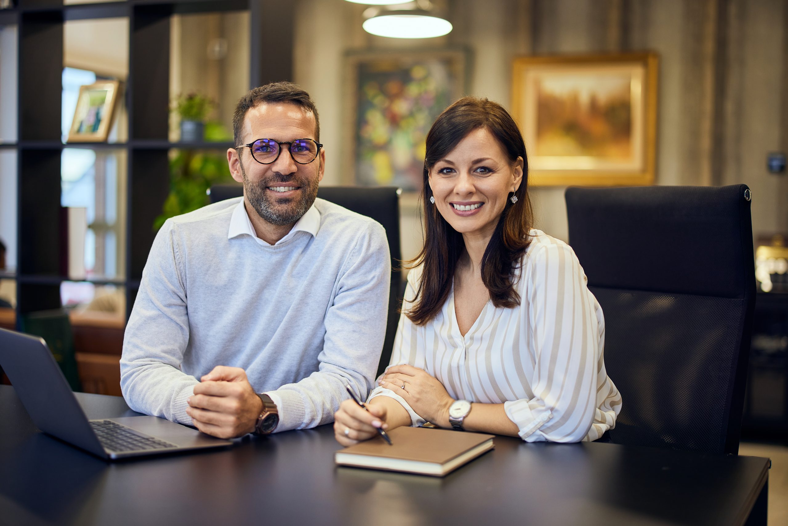 Effective Communication Skills portrait of a smiling businesswoman and businessman working on the same project at the office.
